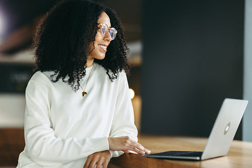 Cheerful businesswoman looking away thoughtfully in an office
