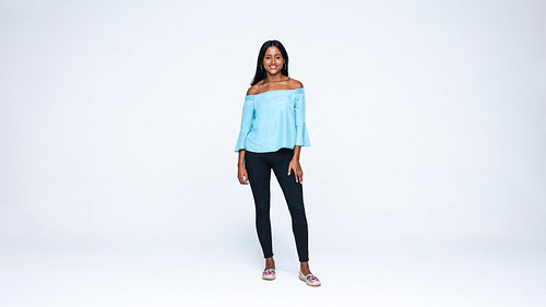 Young woman standing against white background