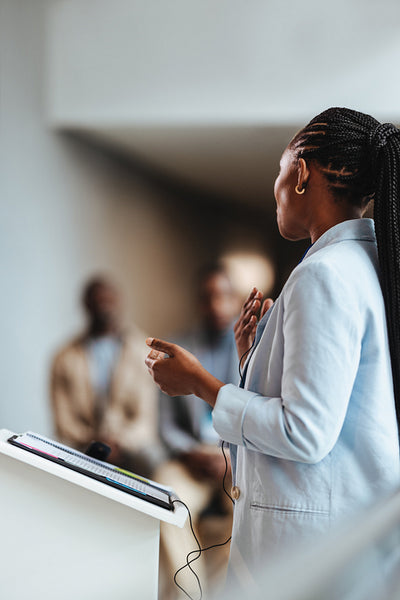 Female entrepreneur giving a speech at a business conference