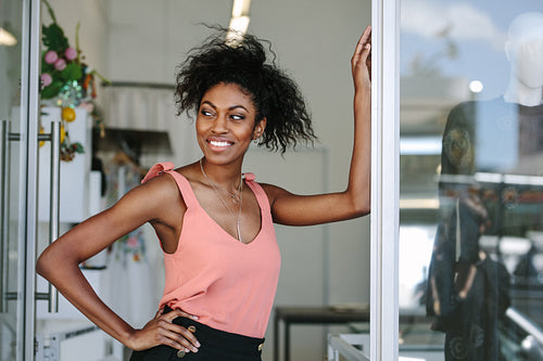 Female fashion designer standing in her boutique.