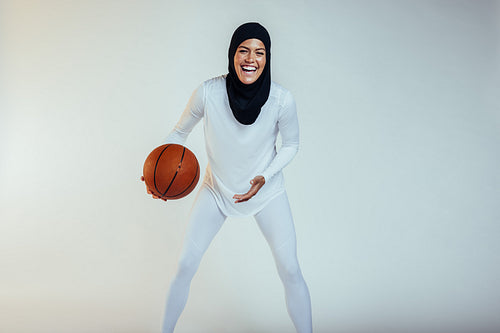 Cheerful basketball athlete on white background