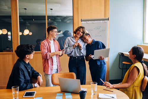 Group of colleagues enjoying a friendly moment during an informal meeting
