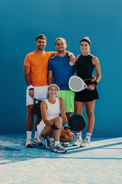 Young people smiling at the camera after a friendly padel match