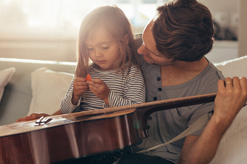 Little girl sitting with her father