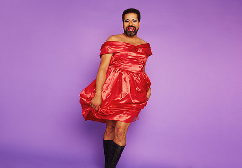 Queer person tanding in female dress