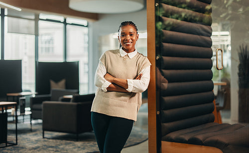 Smiling female manager in coworking office looking at camera