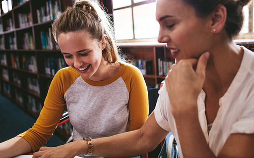 Disabled female student studying with her tutor