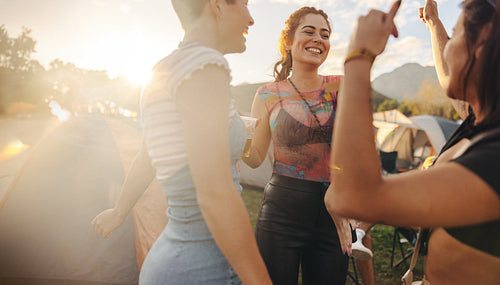 Fun in the sunset: Friends dancing at the summer festival