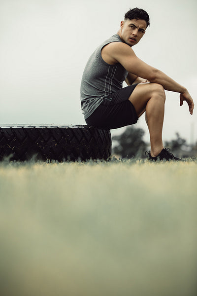 Muscular man resting after cross training outdoors
