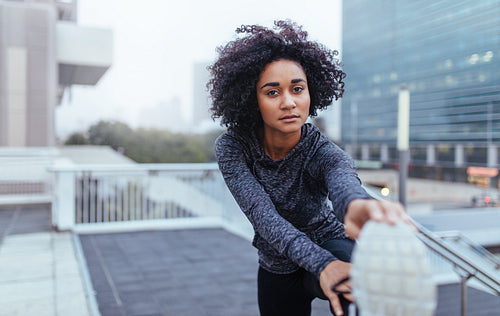 Young woman exercising in jogging gear