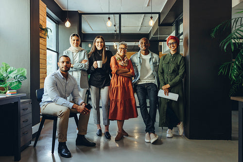 Diverse business team smiling at the camera in an office