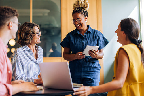 Team of colleagues discussing ideas in a modern office environment