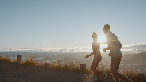 Two runners sprinting in morning