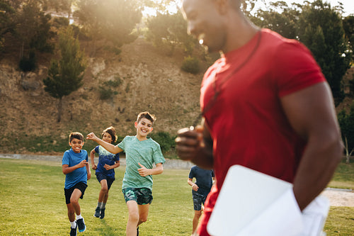 Children running on a school ground during PE