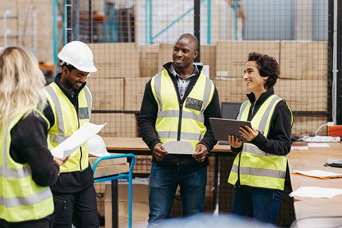 Diverse warehouse workers having a meeting together