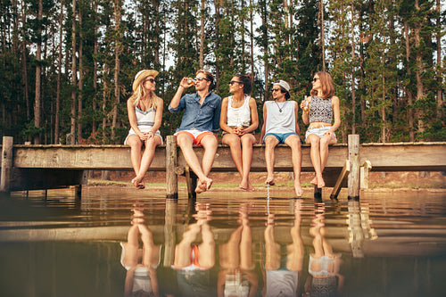 Group of young friends hanging out at the lake