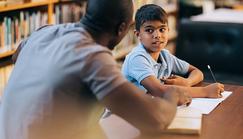 Boy receiving tutoring and academic support in primary school
