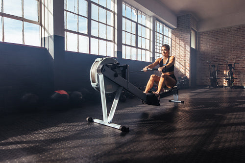 Young woman exercising in gymnasium.
