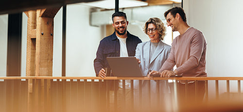 Business woman showing her colleagues a presentation on a laptop