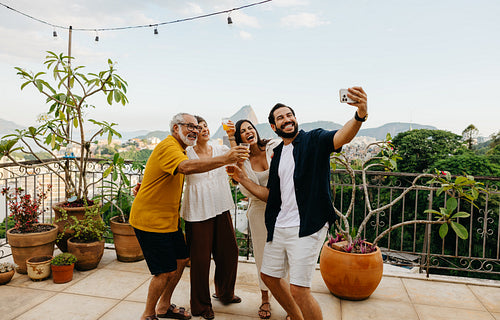 Family taking a selfie and enjoying outdoor patio with scenic views