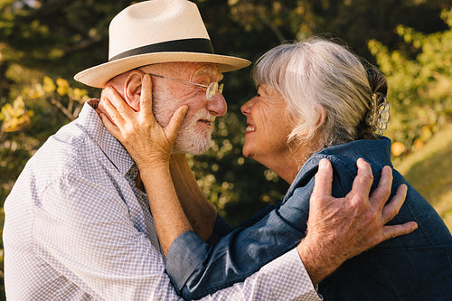 Happy senior couple smiling at each other affectionately