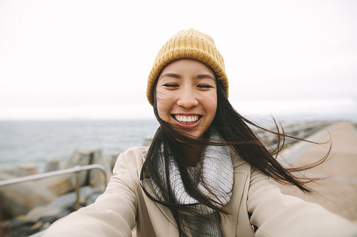 Cheerful asian women standing outdoors on a winter morning
