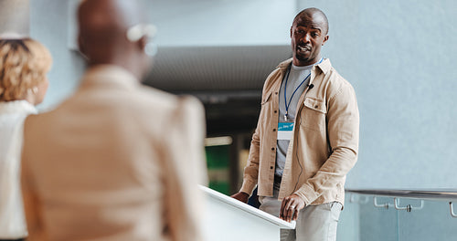 Business man in a business seminar setting speaking with colleagues
