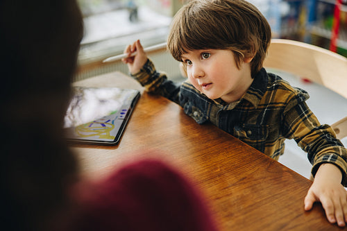 Cute son looking at her mother