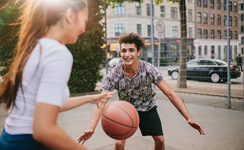 Young friends having a game of basketball