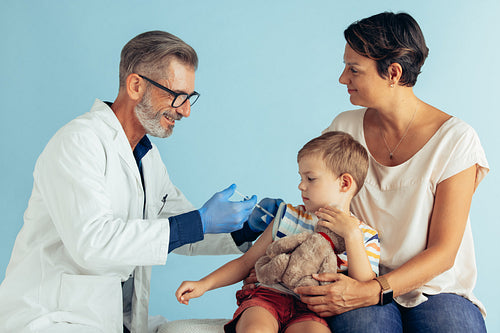 Boy getting flu shot at pediatrician