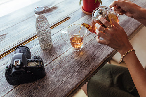 Woman pouring tea in a cup