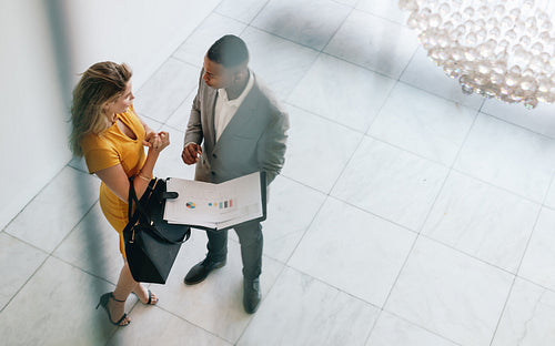 Partners revieving a business document in lobby