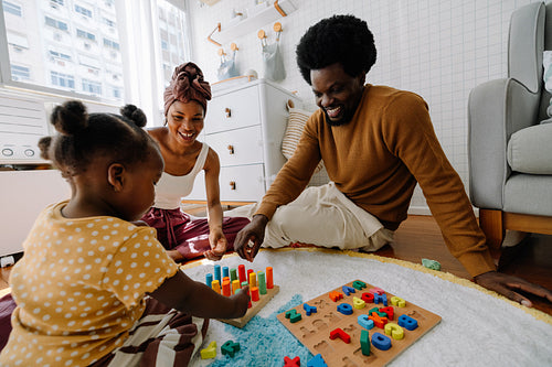 Family playtime at home with colorful blocks