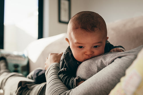 Close up of a baby lying on her mother