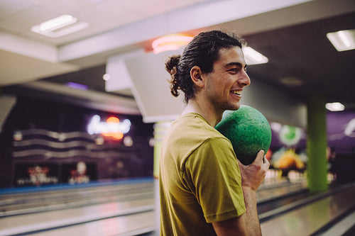 Man playing at bowling alley