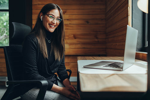 Happy young businesswoman working in a coworking space