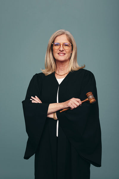 Female judge holding a gavel in a studio