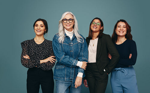 Multicultural group of women smiling at the camera with confiden