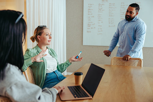 Caucasian female employee leading a productive business meeting with colleagues