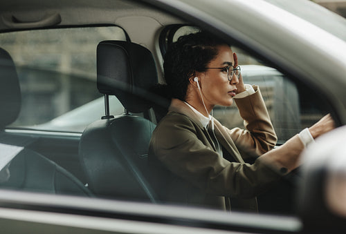 Woman in her daily life driving the car to work