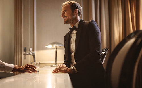 Man talking with a barman at a night club