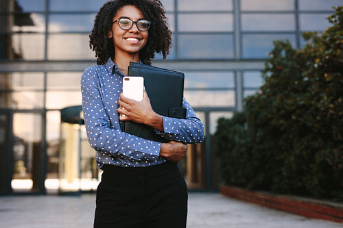 Female executive standing outside office building
