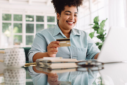 Happy woman doing online shopping at home