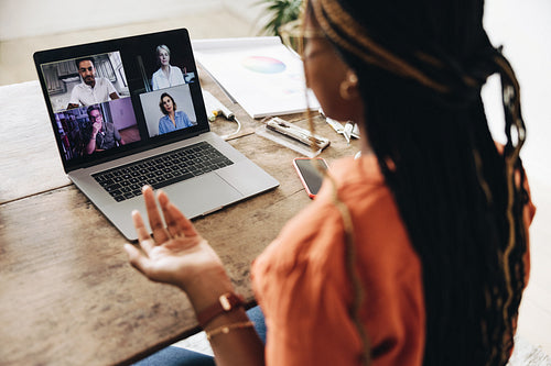 Designer attending a virtual meeting at her desk