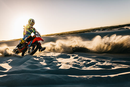 Motocross rider in action on dunes