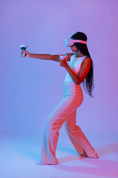 Woman playing a virtual reality game in neon light