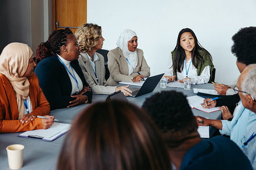 Diverse group of professionals in business meeting discussing ideas