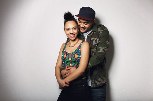 Happy young couple in love on grey background