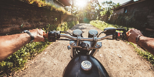Rider driving motorcycle on a rural road