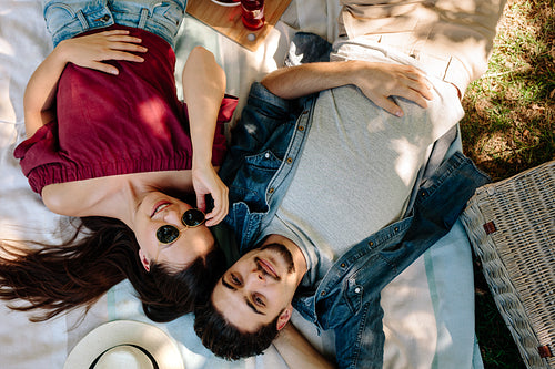 Couple in love lying on picnic blanket